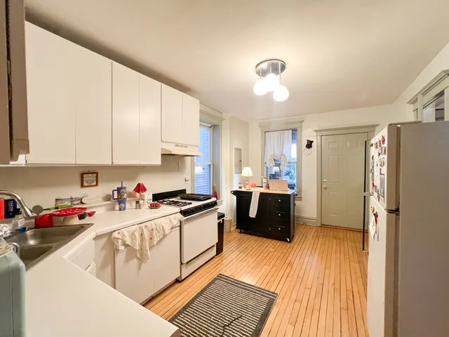 a kitchen with a sink dishwasher stove and refrigerator