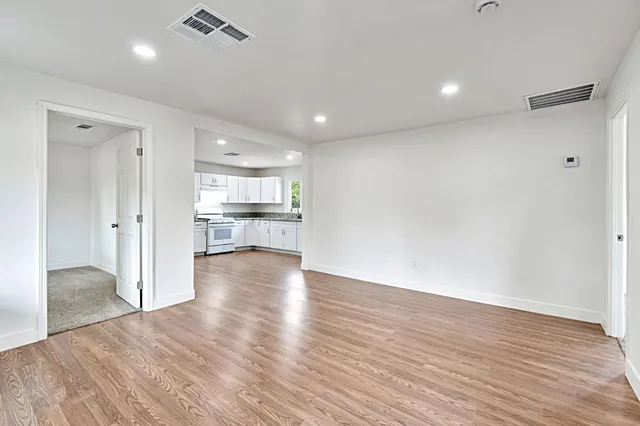 a view of a kitchen with wooden floor and a kitchen
