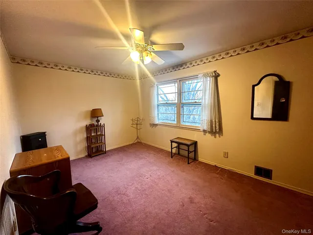 a spacious bedroom with a bed and wooden floor
