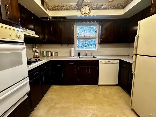 a kitchen with a sink a stove a refrigerator and cabinets