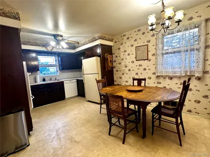 a view of a dining room with furniture and chandelier