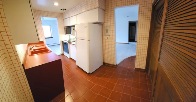 a kitchen with stainless steel appliances a refrigerator and a stove