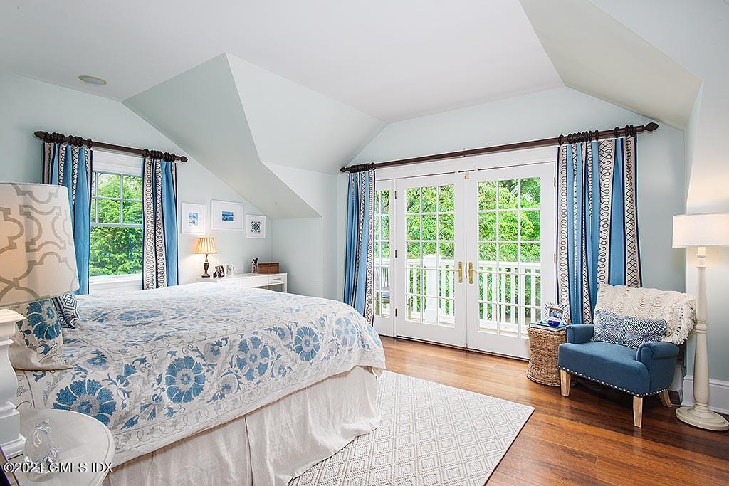 27 Leeward Lane Riverside, CT 06878 - Photo 15 of 38 a bedroom with a bed and a large window
