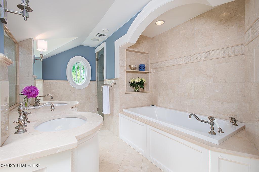 27 Leeward Lane Riverside, CT 06878 - Photo 16 of 38 a bathroom with a bathtub sink and a mirror
