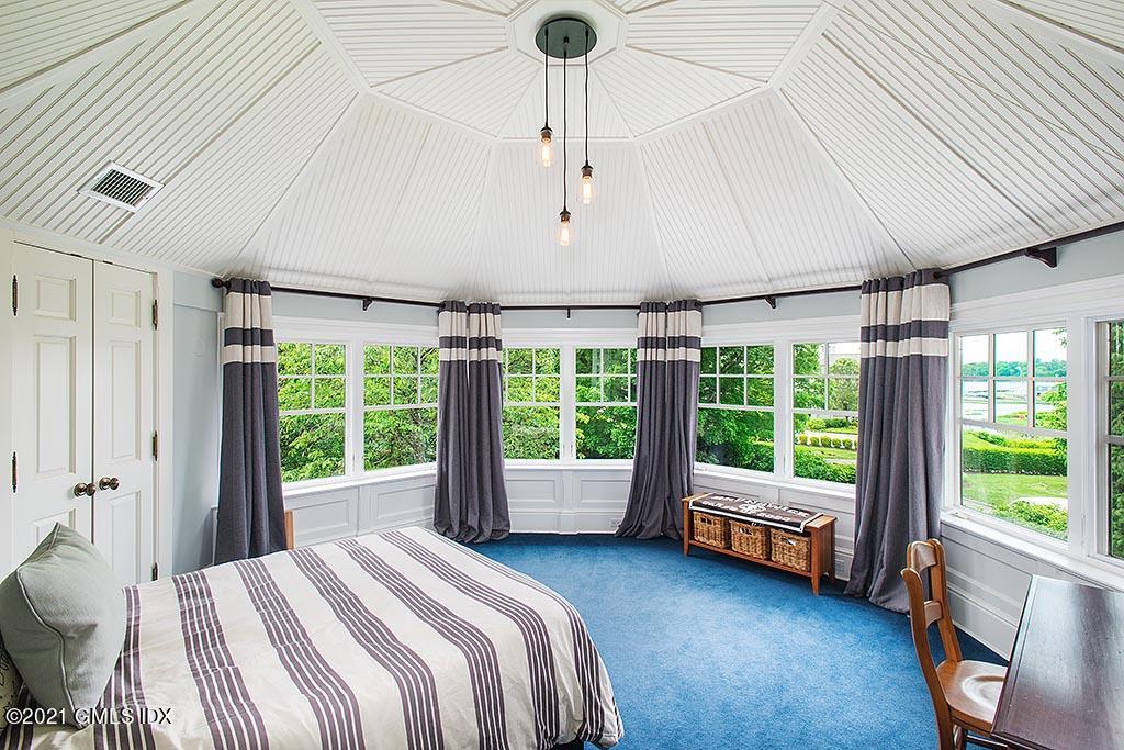 27 Leeward Lane Riverside, CT 06878 - Photo 17 of 38 a spacious bedroom with a bed and a large window