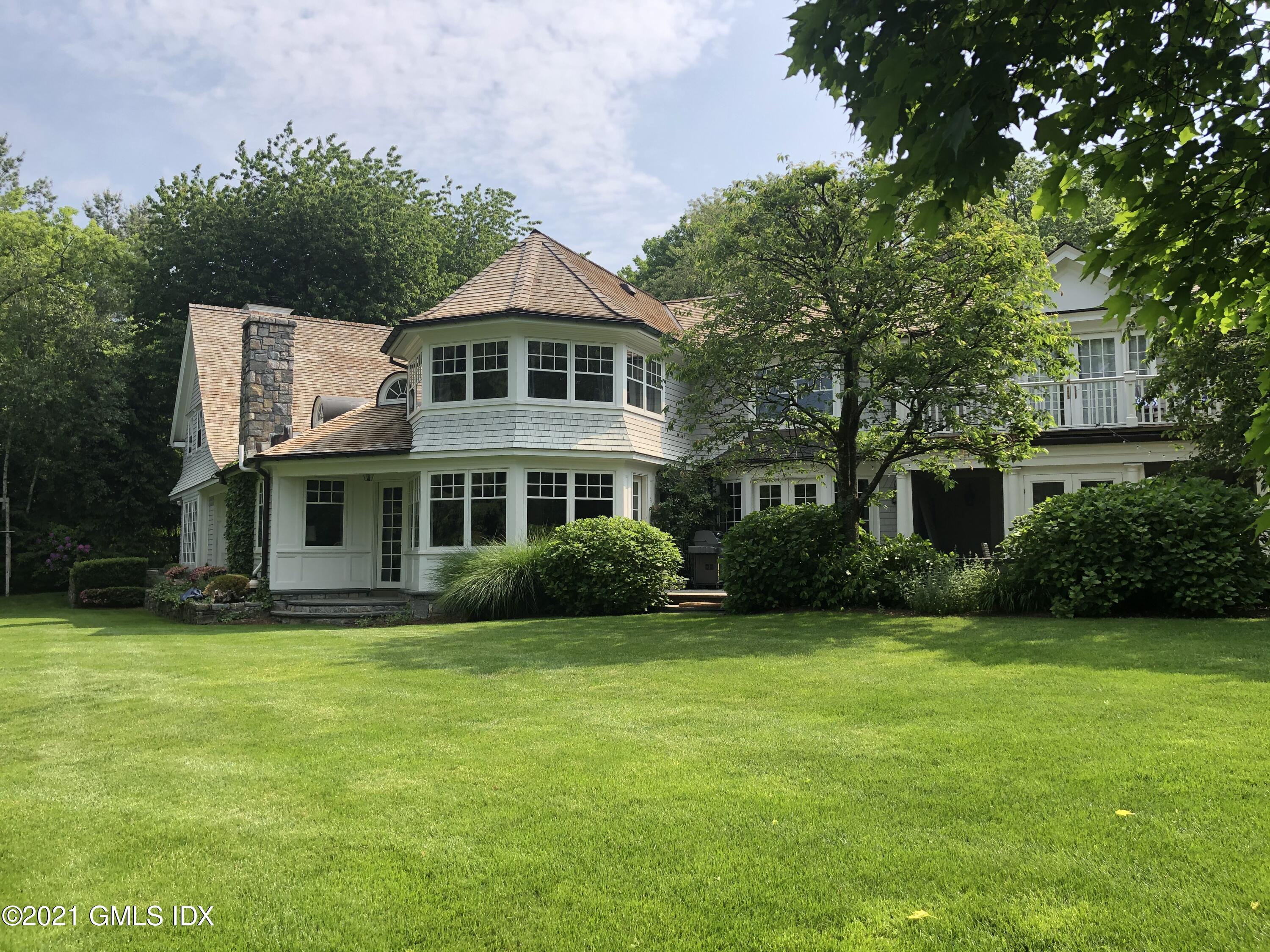 27 Leeward Lane Riverside, CT 06878 - Photo 3 of 38 a front view of a house with a yard
