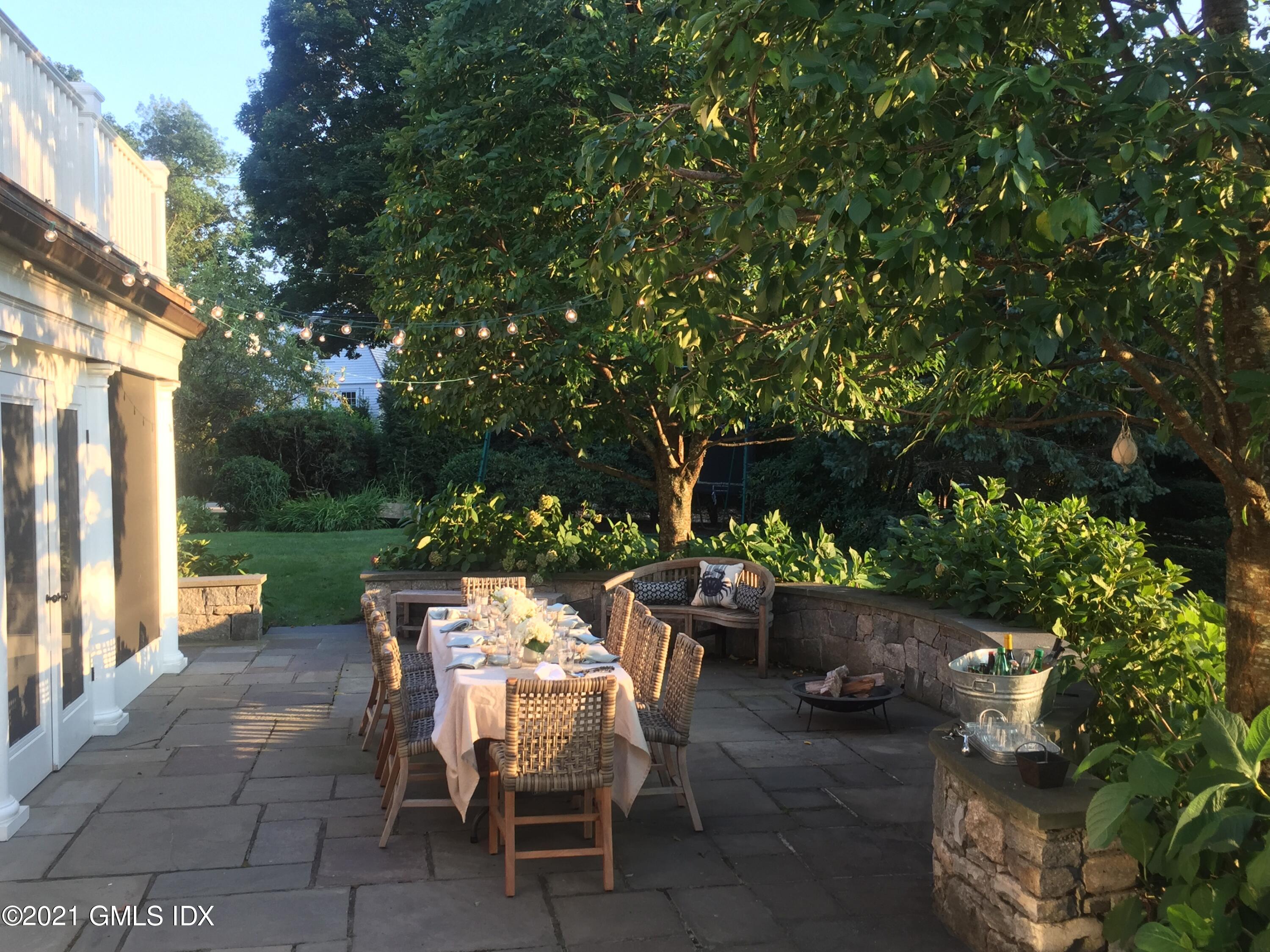 27 Leeward Lane Riverside, CT 06878 - Photo 34 of 38 a view of a patio with table and chairs potted plants and large tree