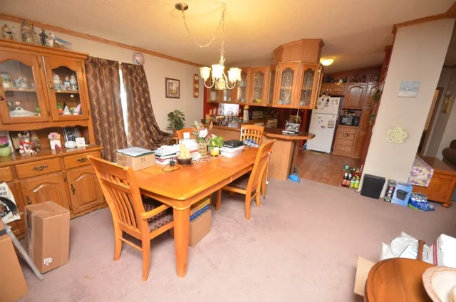 a view of a dining room with furniture and chandelier
