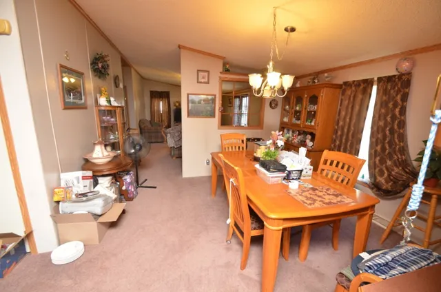 a view of a dining room with furniture and chandelier