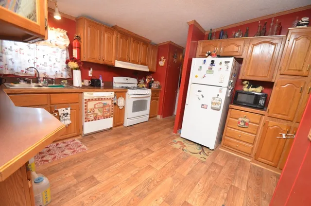 a kitchen with granite countertop a refrigerator and a stove
