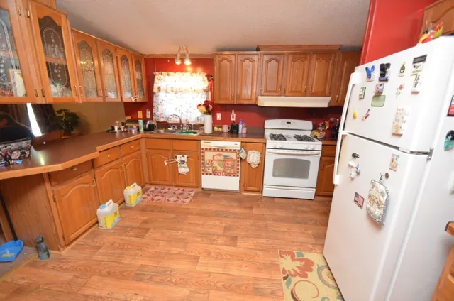 a kitchen with stainless steel appliances a refrigerator a sink a stove a microwave and cabinetry