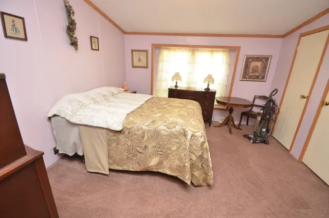 a spacious bedroom with a bed and a table in it