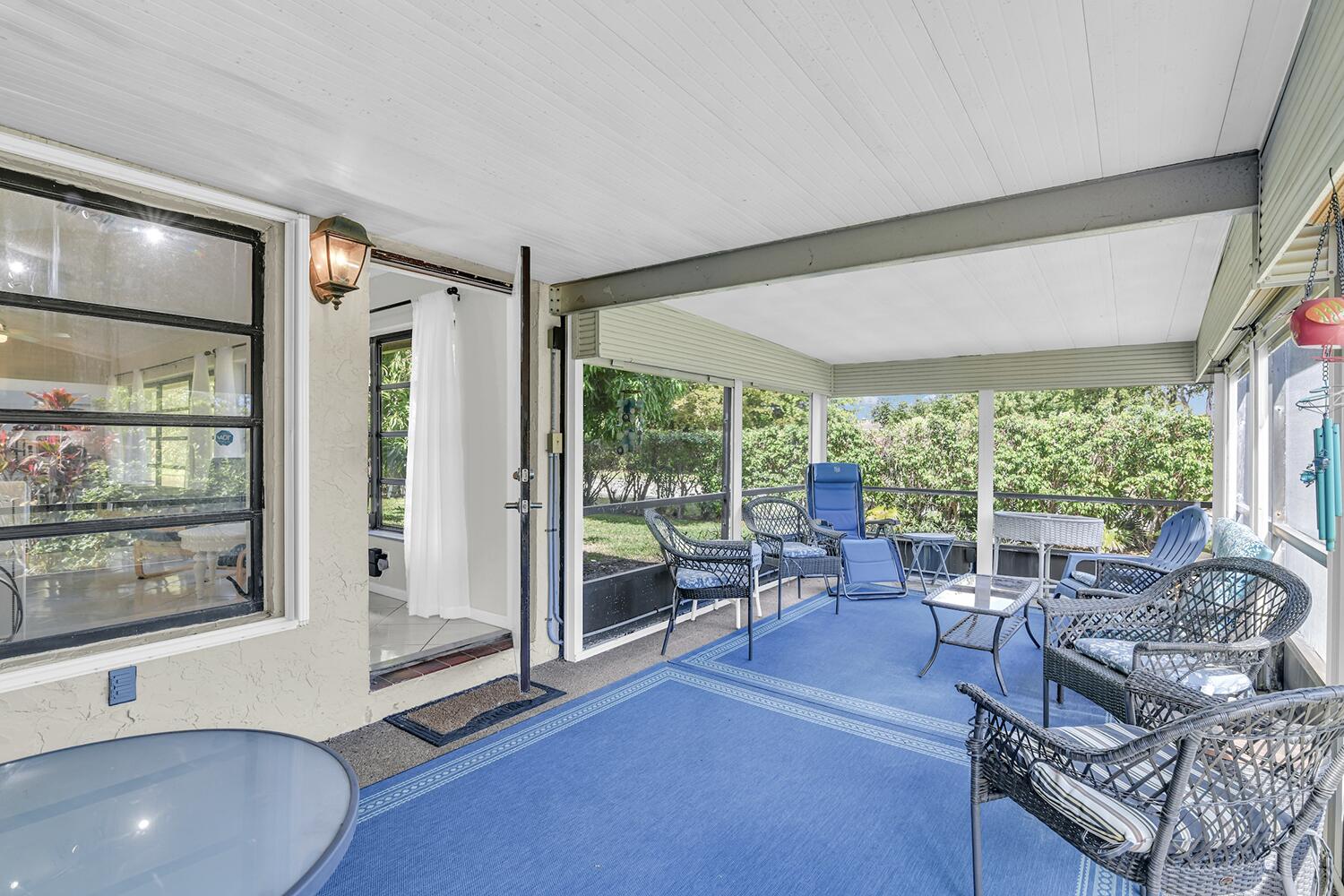 6335 Hitchin Post Way Delray Beach, FL 33484 - Photo 9 of 33 a living room with furniture and large windows