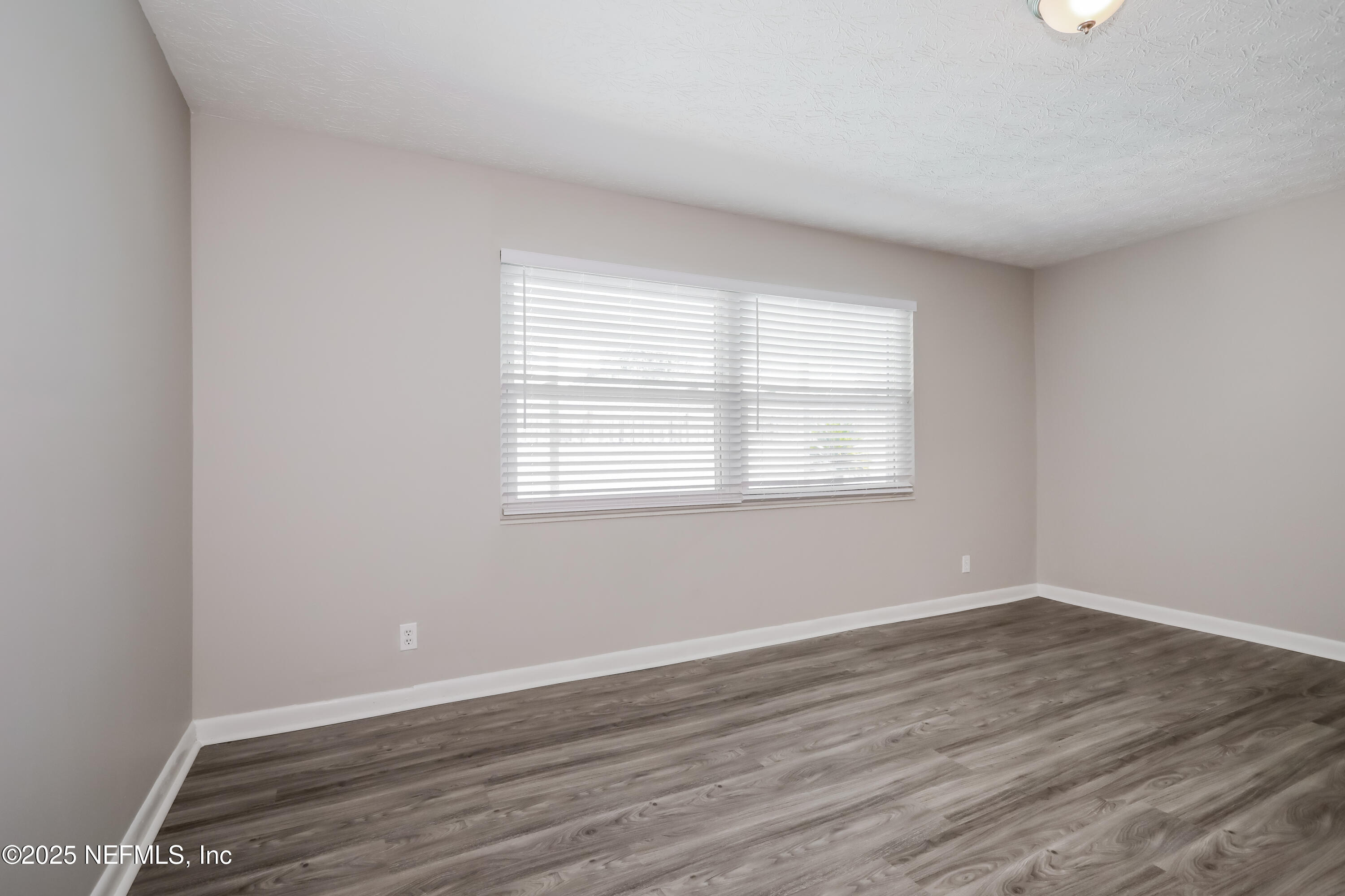 1055 Grove Park Drive Orange Park, FL 32073 - Photo 11 of 15 wooden floor in an empty room with a window
