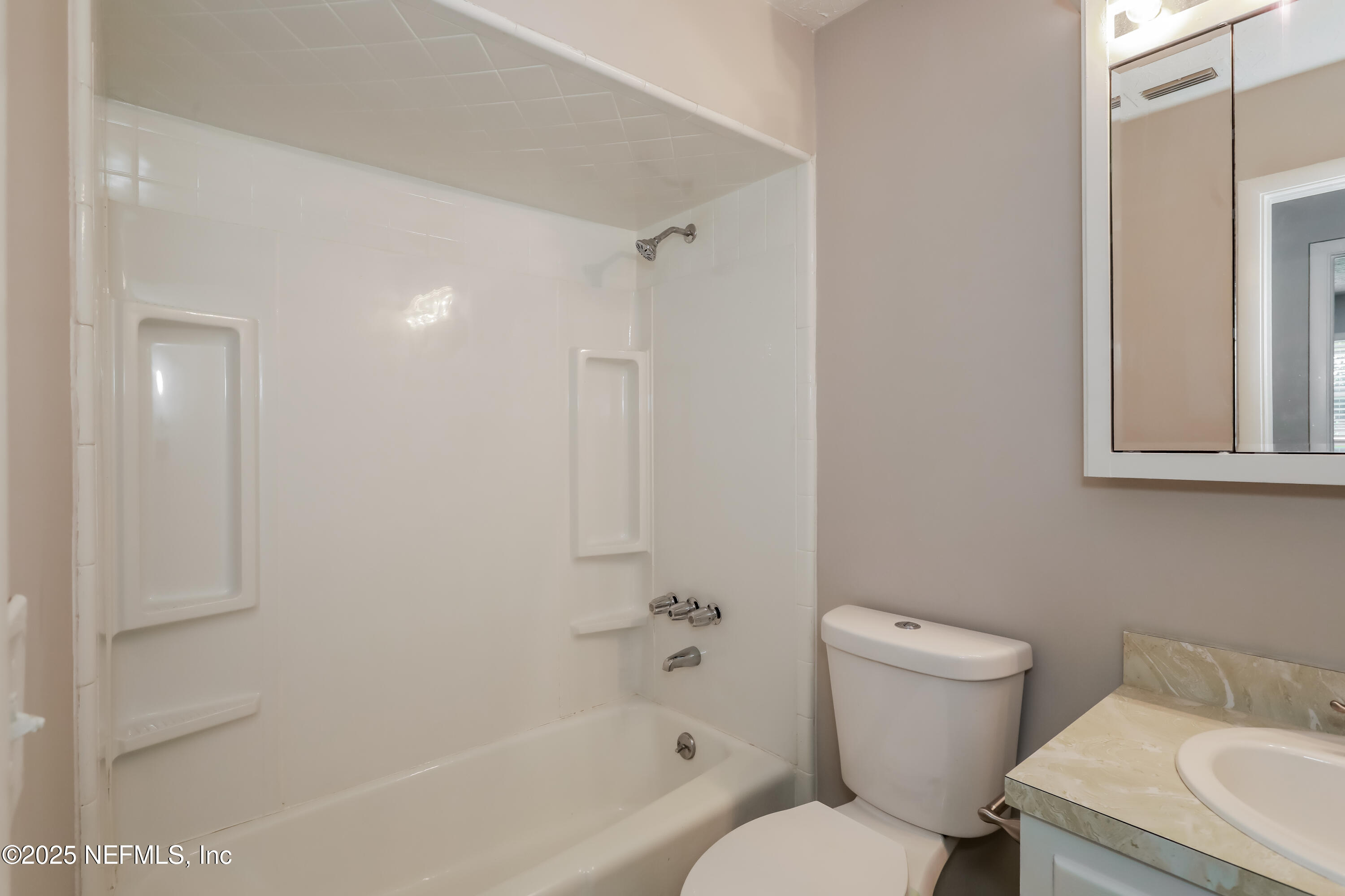 1055 Grove Park Drive Orange Park, FL 32073 - Photo 13 of 15 a white toilet sitting next to a bath tub