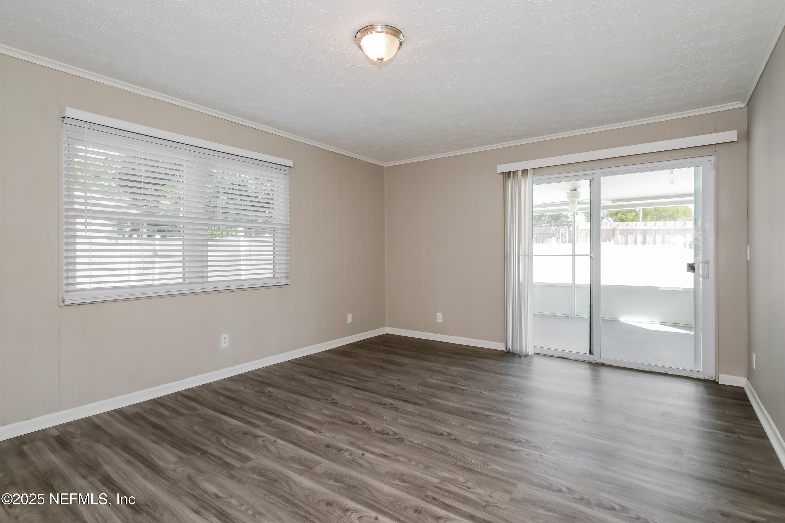 1055 Grove Park Drive Orange Park, FL 32073 - Photo 3 of 15 an empty room with wooden floor and windows