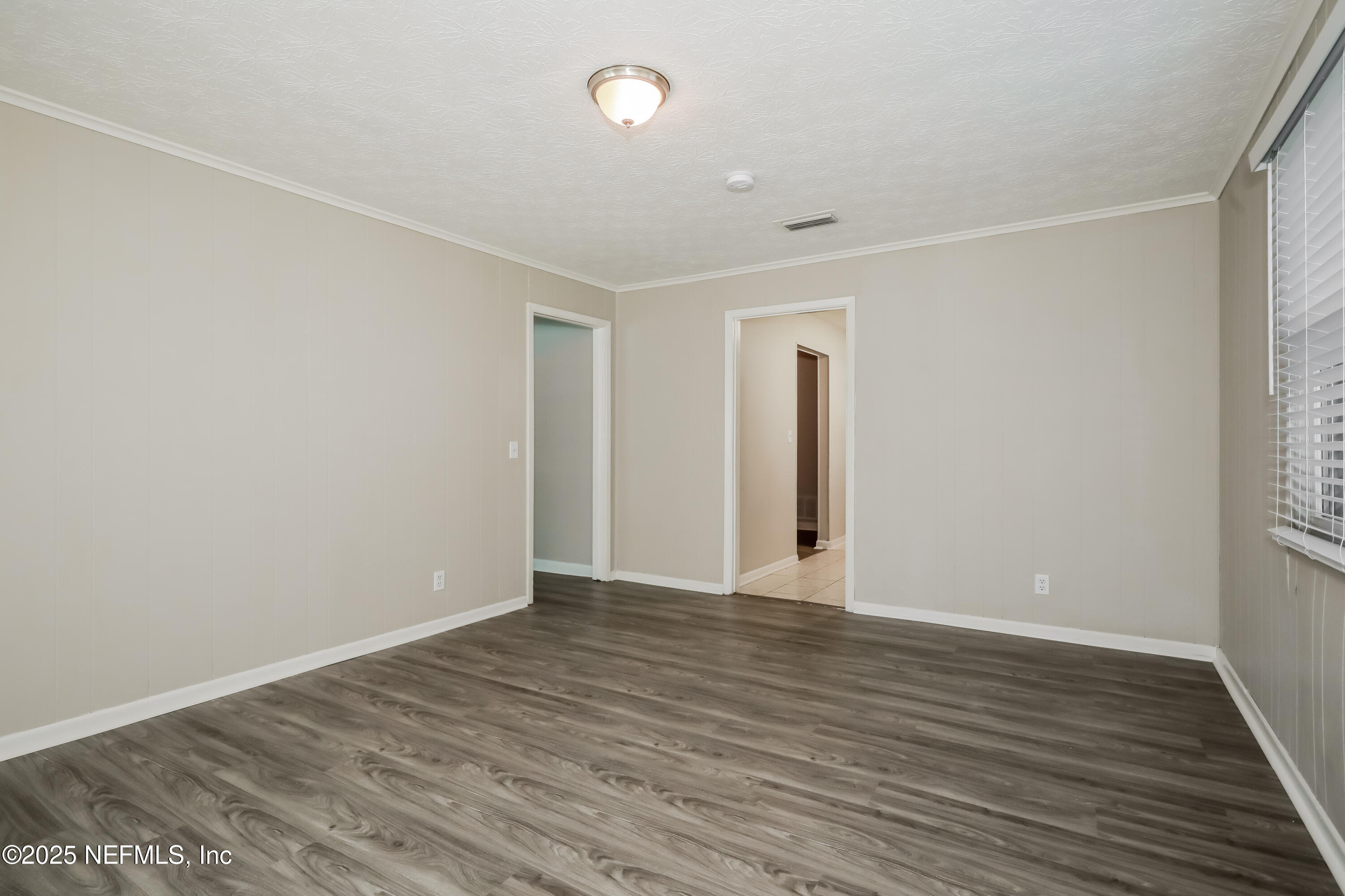 1055 Grove Park Drive Orange Park, FL 32073 - Photo 4 of 15 a view of an empty room with wooden floor