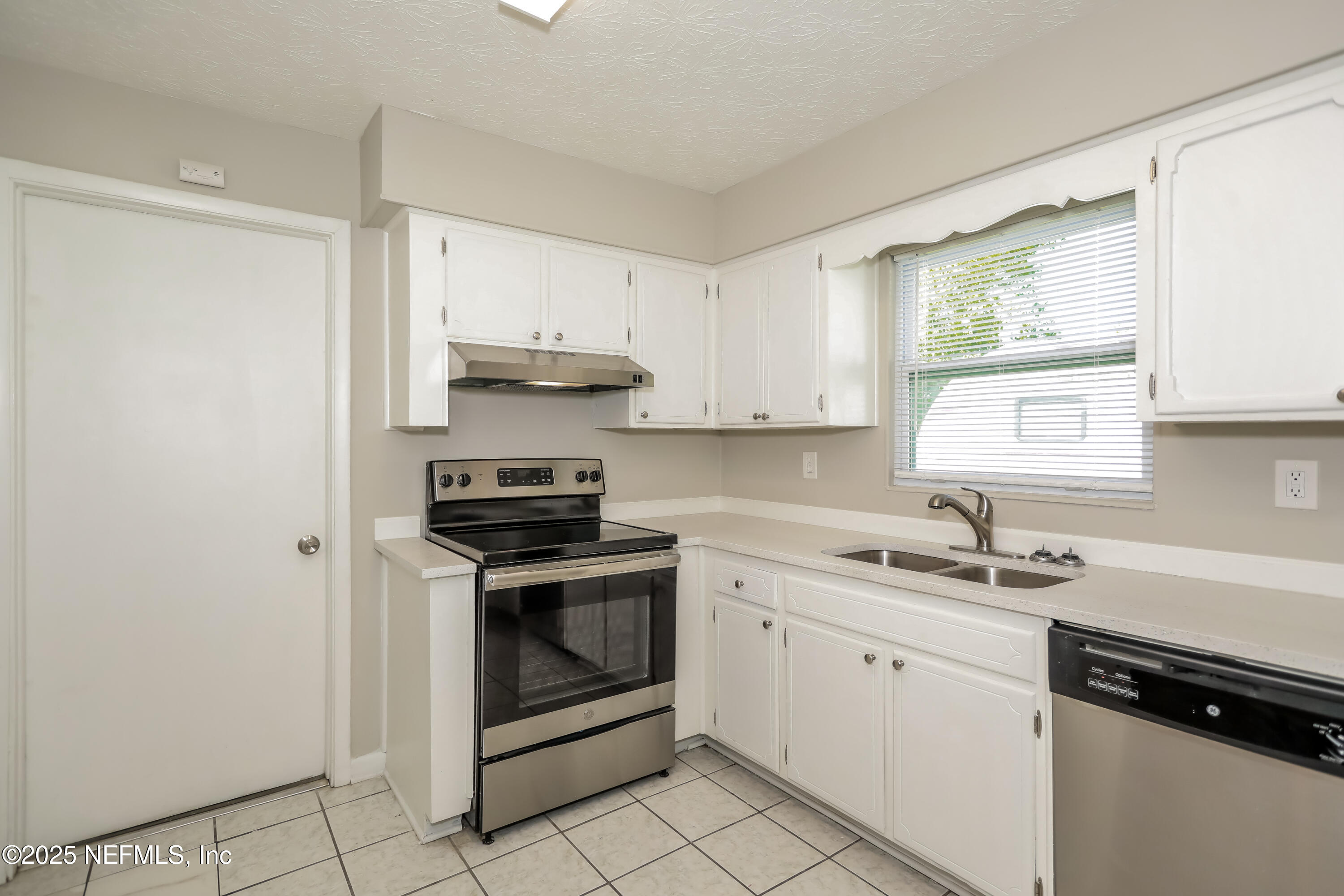 1055 Grove Park Drive Orange Park, FL 32073 - Photo 5 of 15 a kitchen with stainless steel appliances granite countertop a sink stove and window