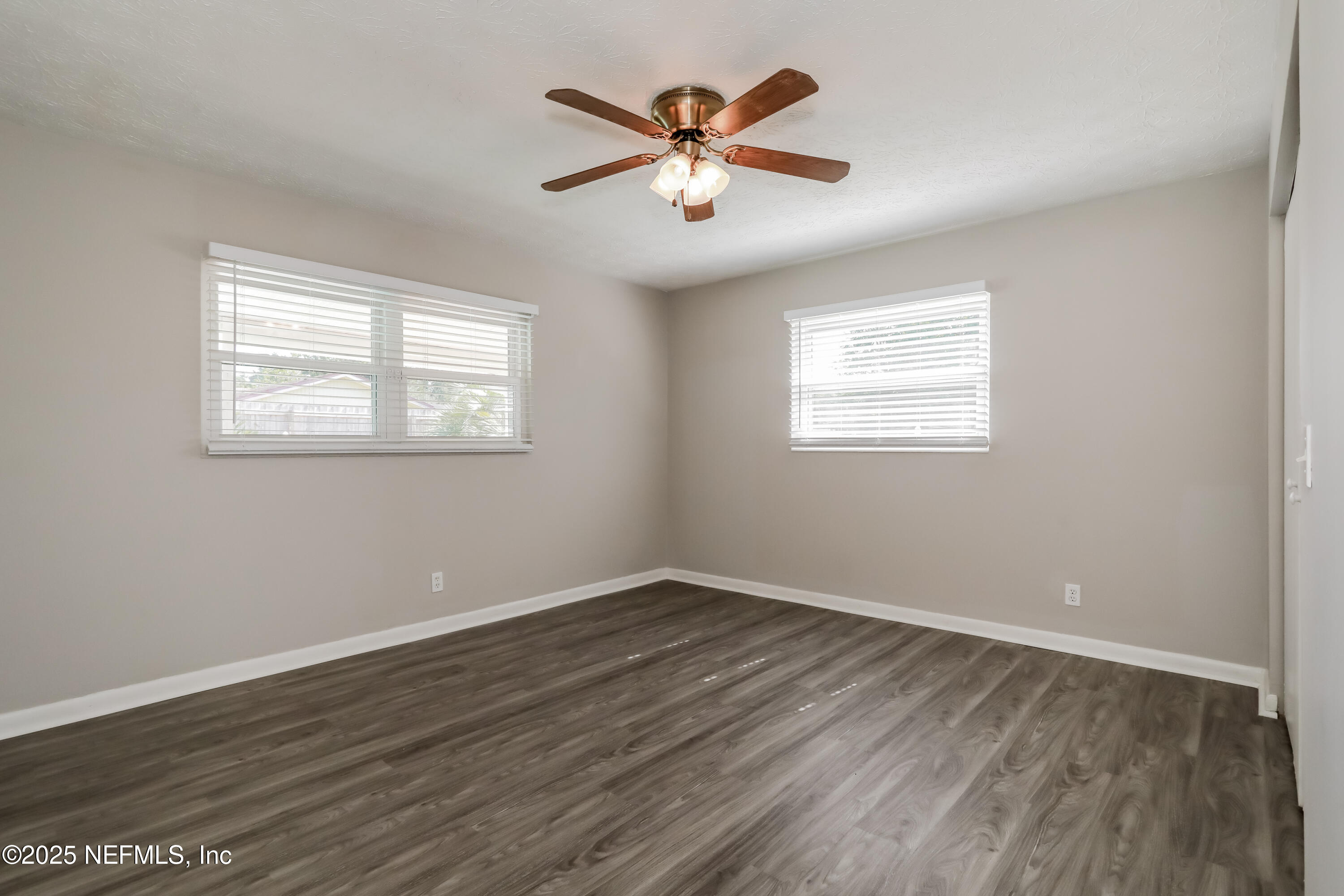 1055 Grove Park Drive Orange Park, FL 32073 - Photo 8 of 15 an empty room with wooden floor and windows