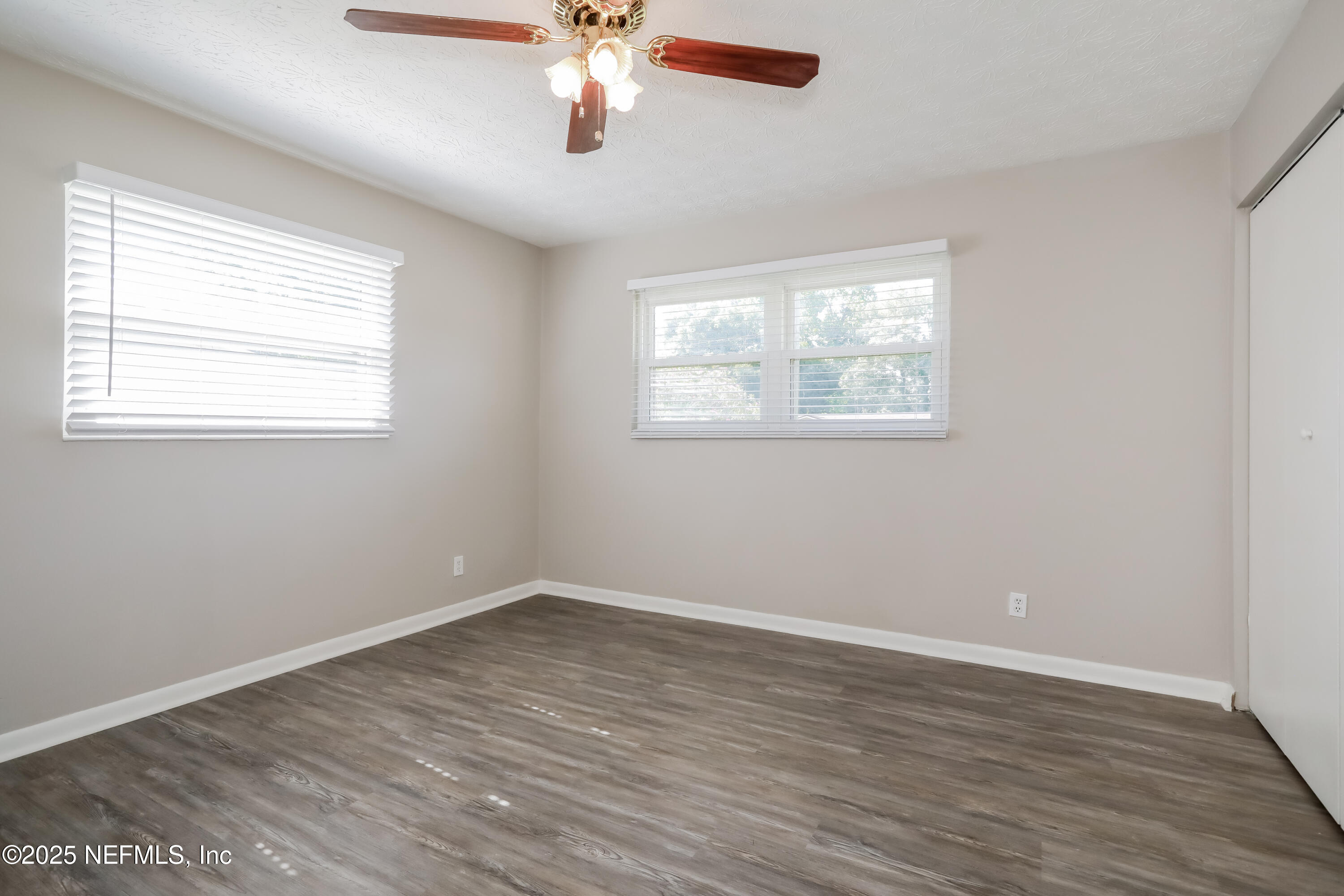 1055 Grove Park Drive Orange Park, FL 32073 - Photo 9 of 15 a view of an empty room with wooden floor and a window