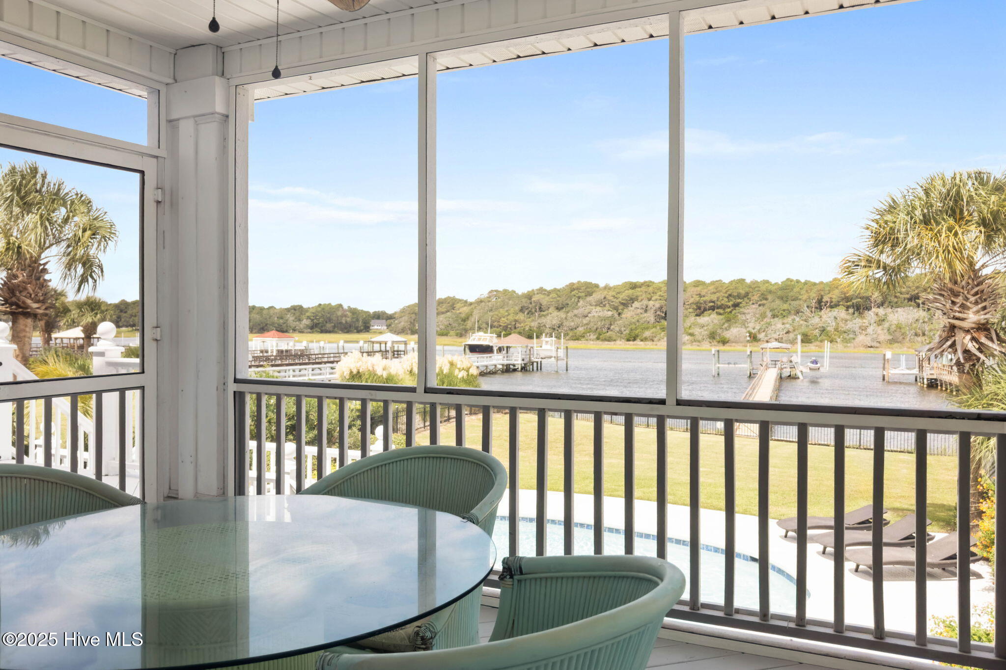 57 Craven Street Ocean Isle Beach, NC 28469 - Photo 24 of 85 Exceptional ICW-front home featuring 5 bedrooms, 5.5 baths, breathtaking water views, private dock with boat lift, and a resort-style outdoor space with pool, porches, and deck.