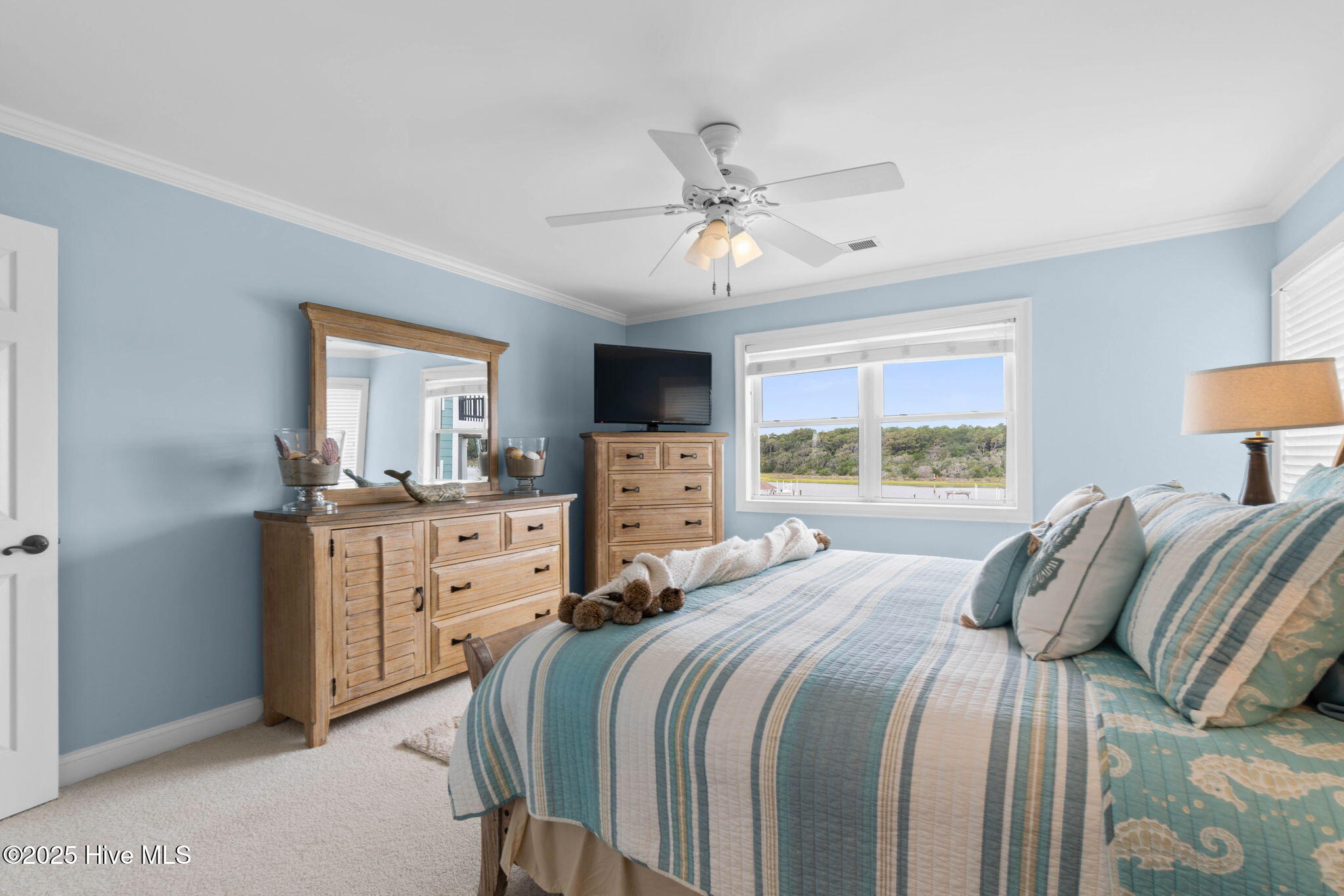 57 Craven Street Ocean Isle Beach, NC 28469 - Photo 39 of 85 Exceptional ICW-front home featuring 5 bedrooms, 5.5 baths, breathtaking water views, private dock with boat lift, and a resort-style outdoor space with pool, porches, and deck.