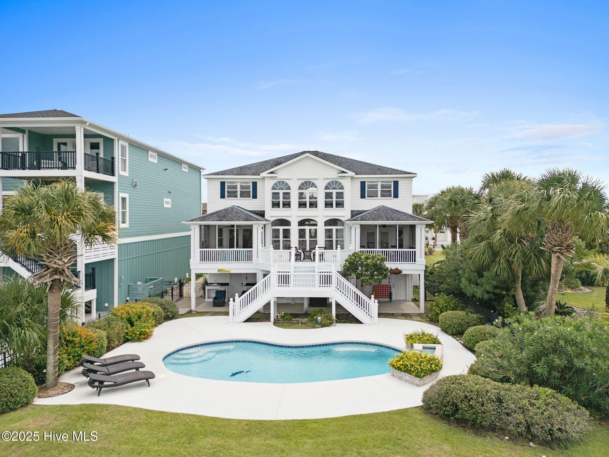 57 Craven Street Ocean Isle Beach, NC 28469 - Photo 57 of 85 Exceptional ICW-front home featuring 5 bedrooms, 5.5 baths, breathtaking water views, private dock with boat lift, and a resort-style outdoor space with pool, porches, and deck.