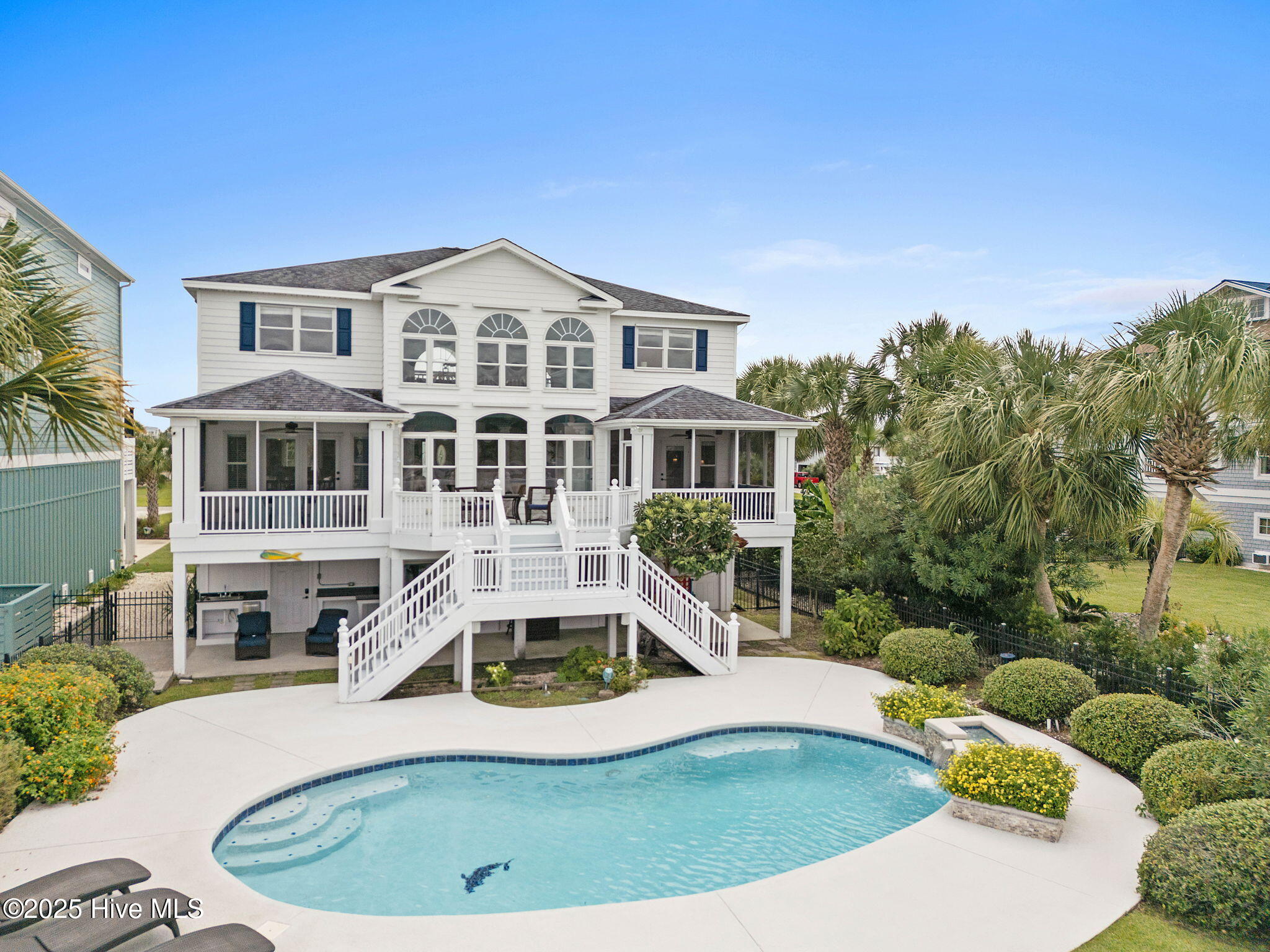 57 Craven Street Ocean Isle Beach, NC 28469 - Photo 58 of 85 Exceptional ICW-front home featuring 5 bedrooms, 5.5 baths, breathtaking water views, private dock with boat lift, and a resort-style outdoor space with pool, porches, and deck.