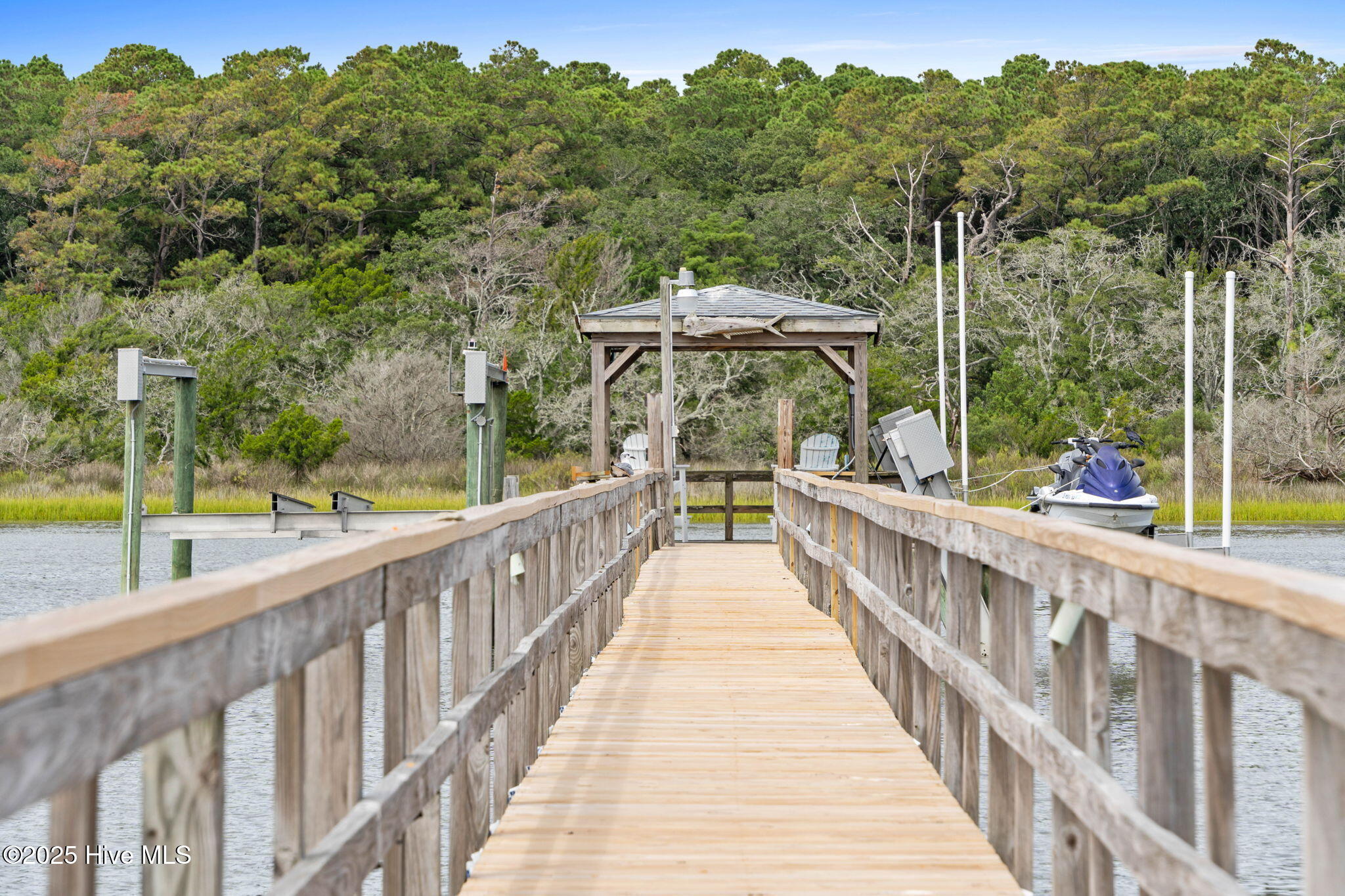 57 Craven Street Ocean Isle Beach, NC 28469 - Photo 59 of 85 Exceptional ICW-front home featuring 5 bedrooms, 5.5 baths, breathtaking water views, private dock with boat lift, and a resort-style outdoor space with pool, porches, and deck.