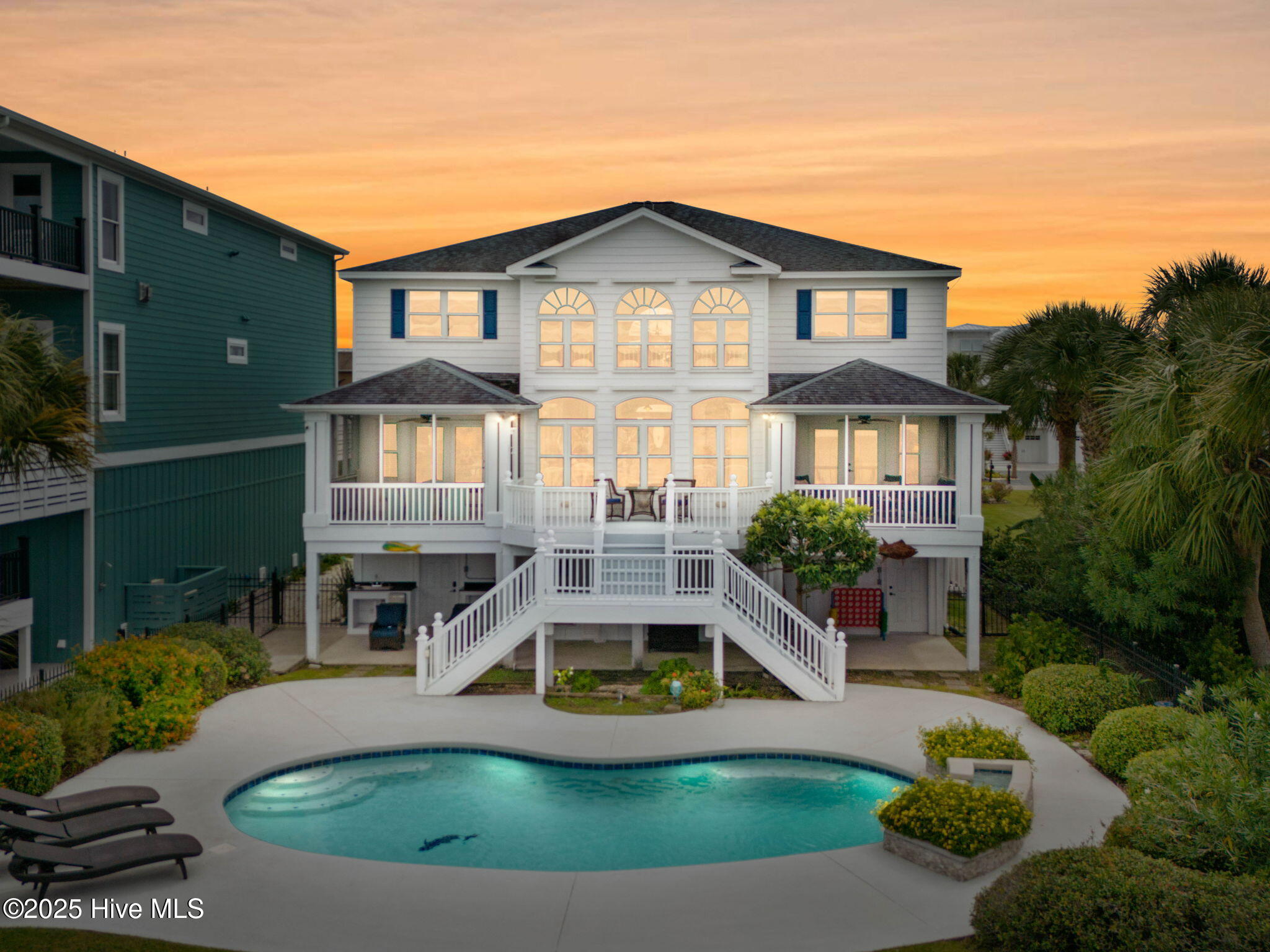 57 Craven Street Ocean Isle Beach, NC 28469 - Photo 4 of 85 Exceptional ICW-front home featuring 5 bedrooms, 5.5 baths, breathtaking water views, private dock with boat lift, and a resort-style outdoor space with pool, porches, and deck.