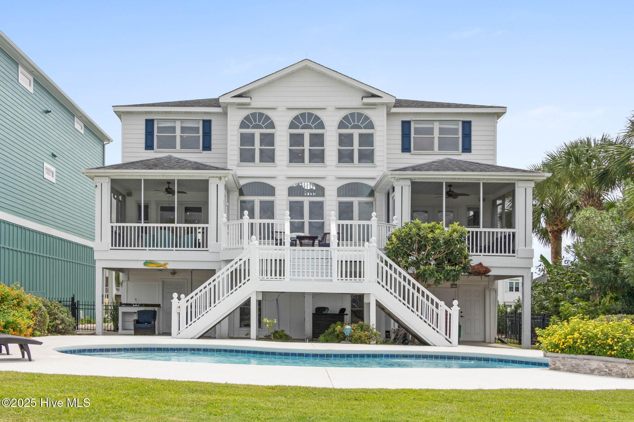 57 Craven Street Ocean Isle Beach, NC 28469 - Photo 63 of 85 Exceptional ICW-front home featuring 5 bedrooms, 5.5 baths, breathtaking water views, private dock with boat lift, and a resort-style outdoor space with pool, porches, and deck.