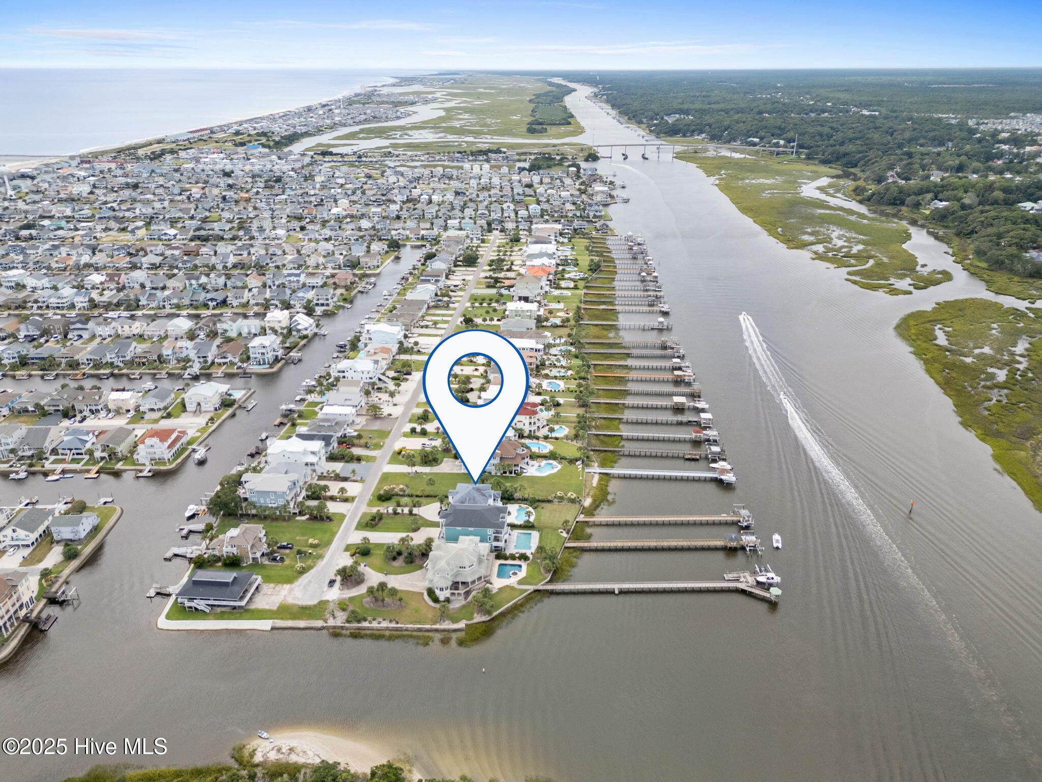57 Craven Street Ocean Isle Beach, NC 28469 - Photo 65 of 85 Exceptional ICW-front home featuring 5 bedrooms, 5.5 baths, breathtaking water views, private dock with boat lift, and a resort-style outdoor space with pool, porches, and deck.