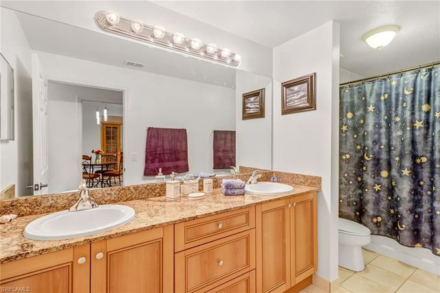 a bathroom with a sink double vanity and a toilet