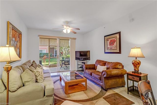 a living room with furniture and a lamp