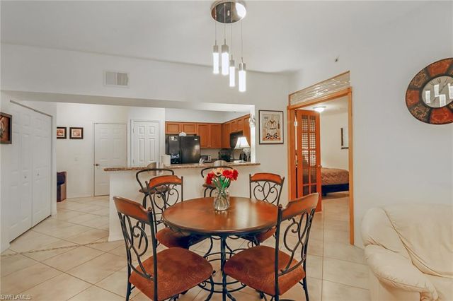 a view of a dining room with furniture and a chandelier