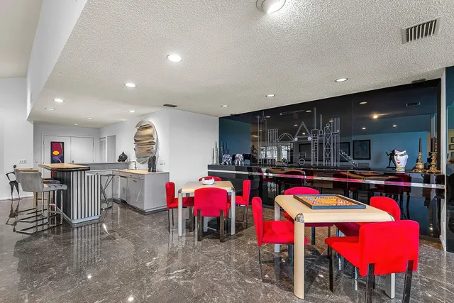 a living room with furniture hard wood floor and a table