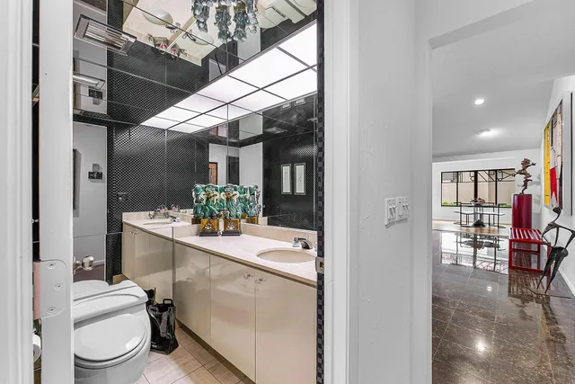 a room with furniture pool table and window