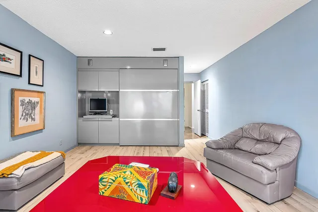 a view of a house with a yard and a large tree