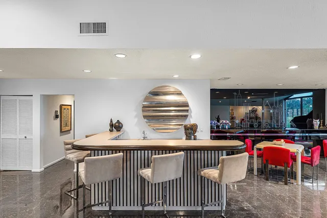 a view of a patio with dining table and chairs