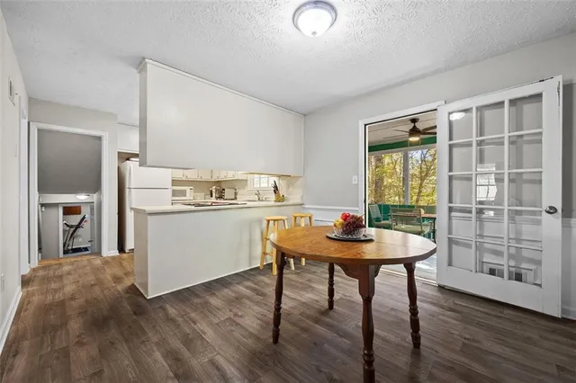a kitchen with a table chairs and wooden floor