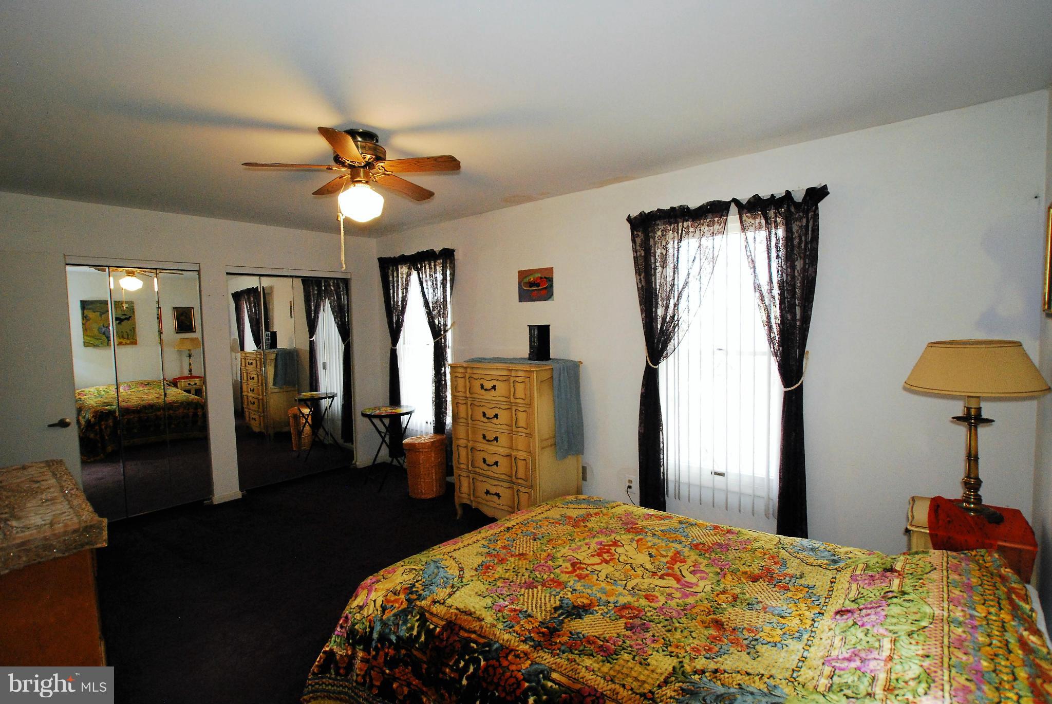 46 Robin Ridge Court Baltimore, MD 21234 - Photo 14 of 22 a bedroom with a bed and a chandelier