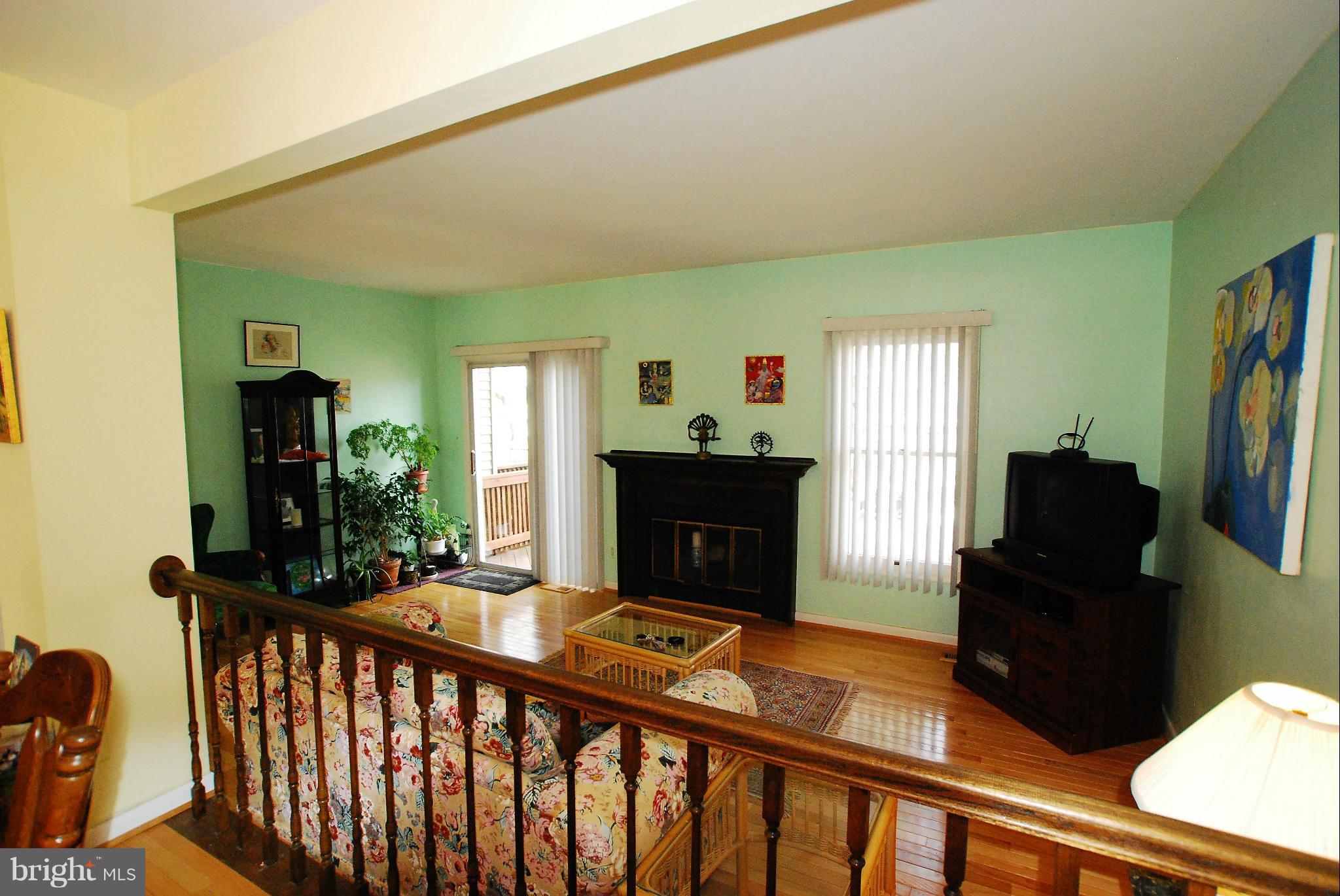 46 Robin Ridge Court Baltimore, MD 21234 - Photo 6 of 22 a living room with furniture a fireplace and a flat screen tv