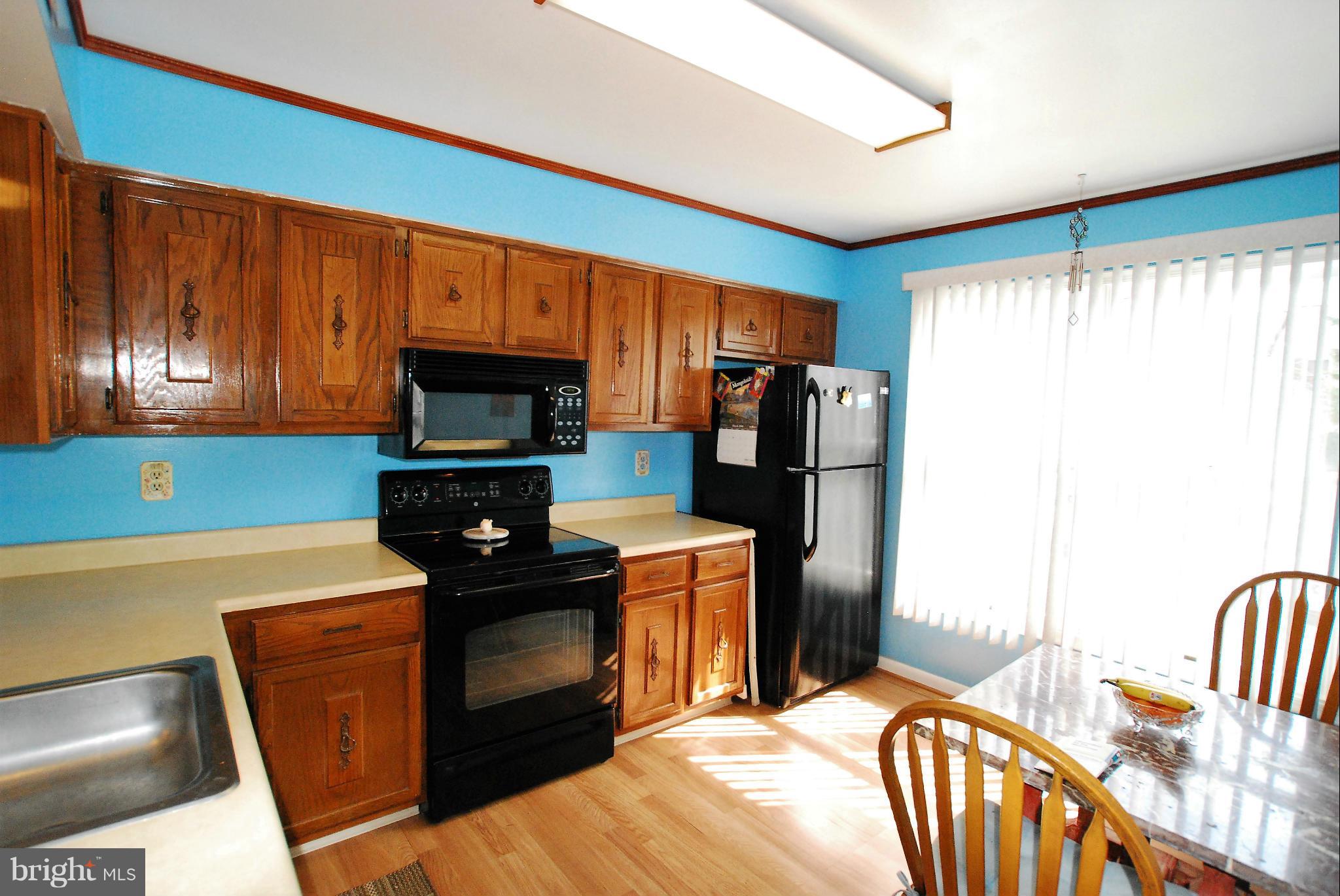 46 Robin Ridge Court Baltimore, MD 21234 - Photo 9 of 22 a kitchen with stainless steel appliances granite countertop a refrigerator a stove top oven a sink and dishwasher