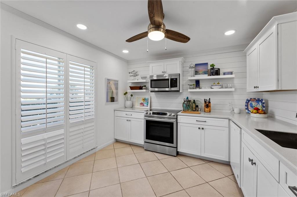 a kitchen with a white cabinets and white appliances