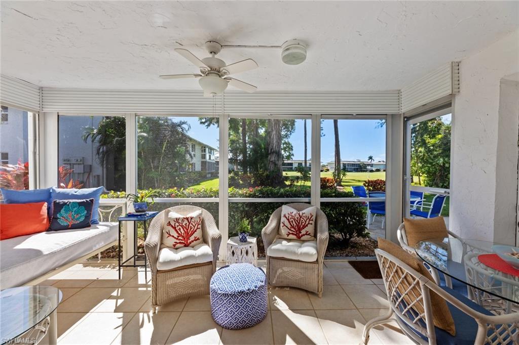 263 Candycane Lane, Unit 7 Naples, FL 34112 - Photo 11 of 50 a living room with furniture and a large window