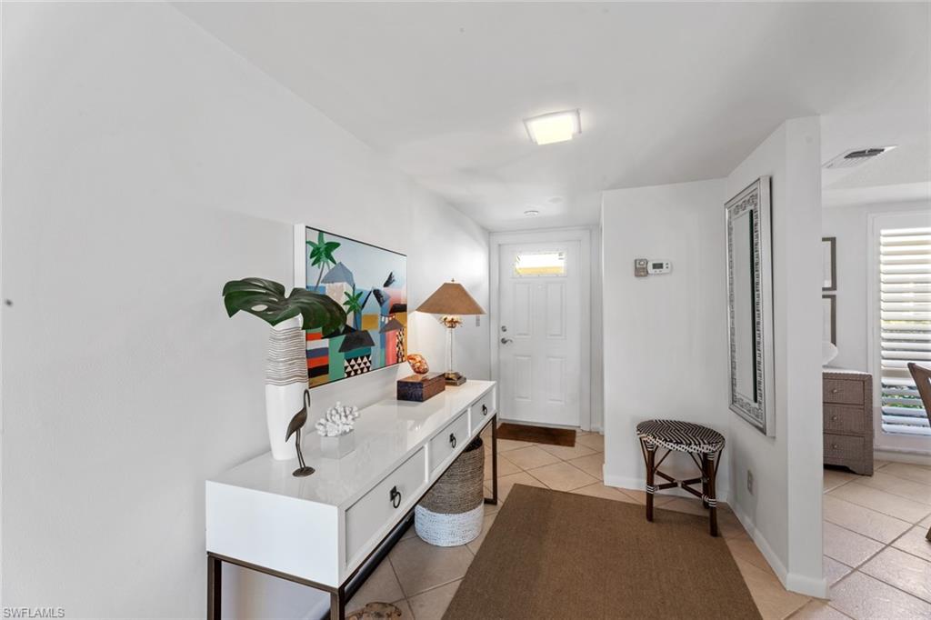 263 Candycane Lane, Unit 7 Naples, FL 34112 - Photo 12 of 50 a living room with furniture and a potted plant