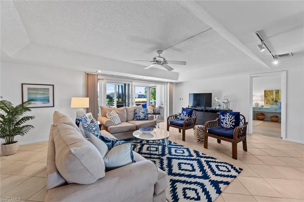 263 Candycane Lane, Unit 7 Naples, FL 34112 - Photo 13 of 50 a living room with furniture and a flat screen tv