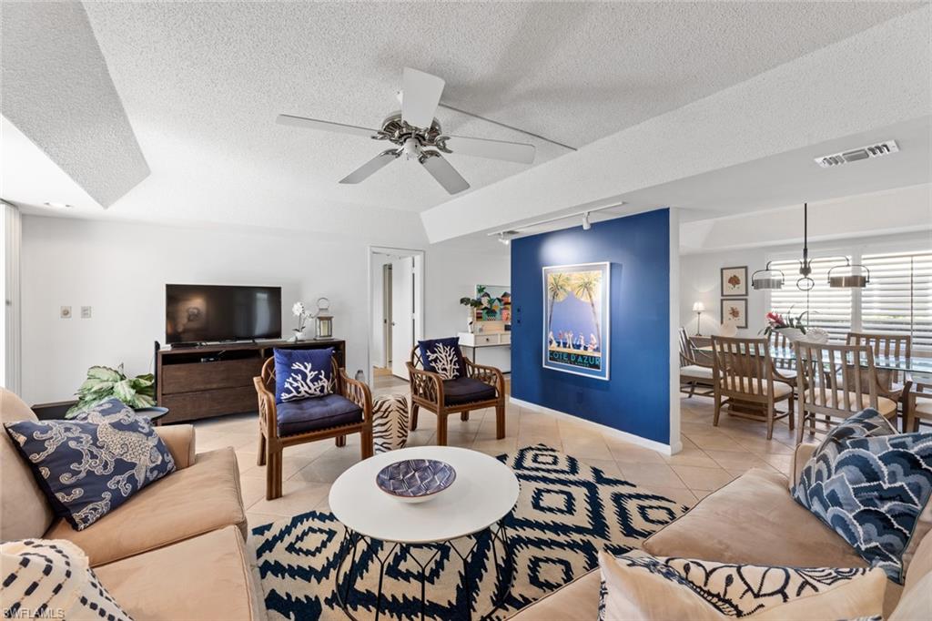 263 Candycane Lane, Unit 7 Naples, FL 34112 - Photo 14 of 50 a living room with furniture and a flat screen tv