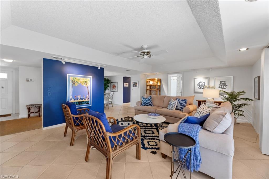 263 Candycane Lane, Unit 7 Naples, FL 34112 - Photo 16 of 50 a living room with furniture and a window