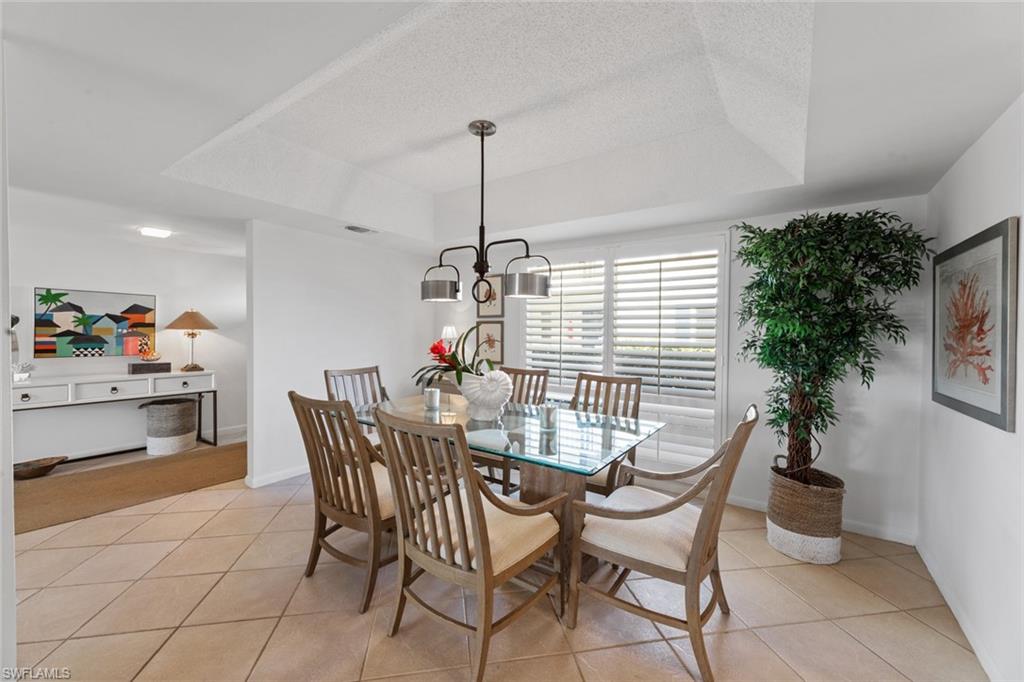 263 Candycane Lane, Unit 7 Naples, FL 34112 - Photo 17 of 50 a dining room with furniture and window